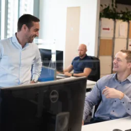 Two employees having a fun conversation in the Cundall office